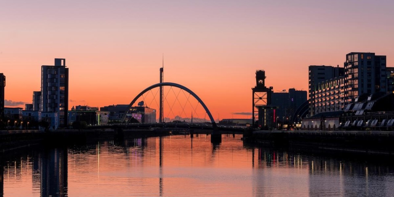 Glasgow's Clyde Arc against and orange and pink sunset