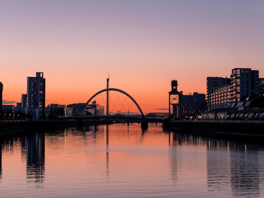 Glasgow's Clyde Arc against and orange and pink sunset