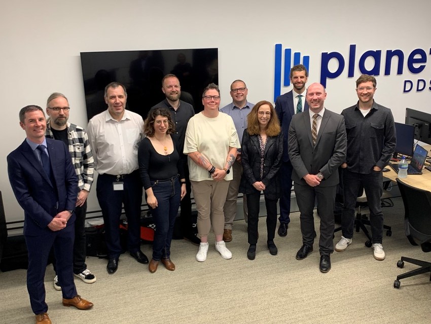Planet DDS employees gather at their new offices in the Garment Factory.