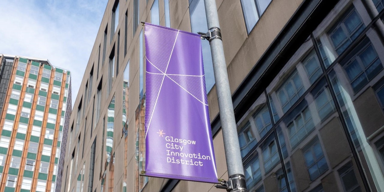 A GCID Banner adorns a lighting column in the District