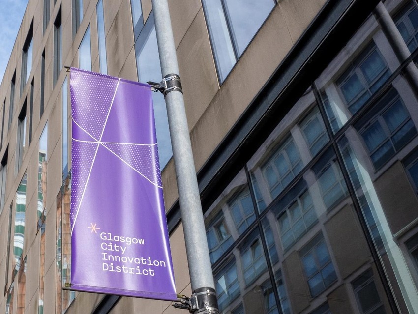 A GCID Banner adorns a lighting column in the District